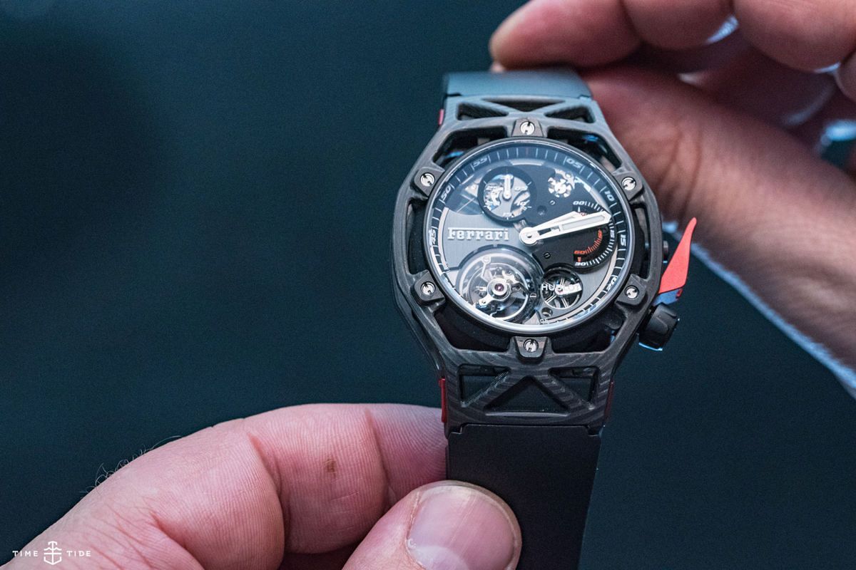 A hand holding a watch
