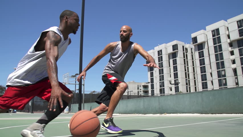 two people playing basketball